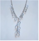 Pale faceted blue beads fall gracefully down chain.